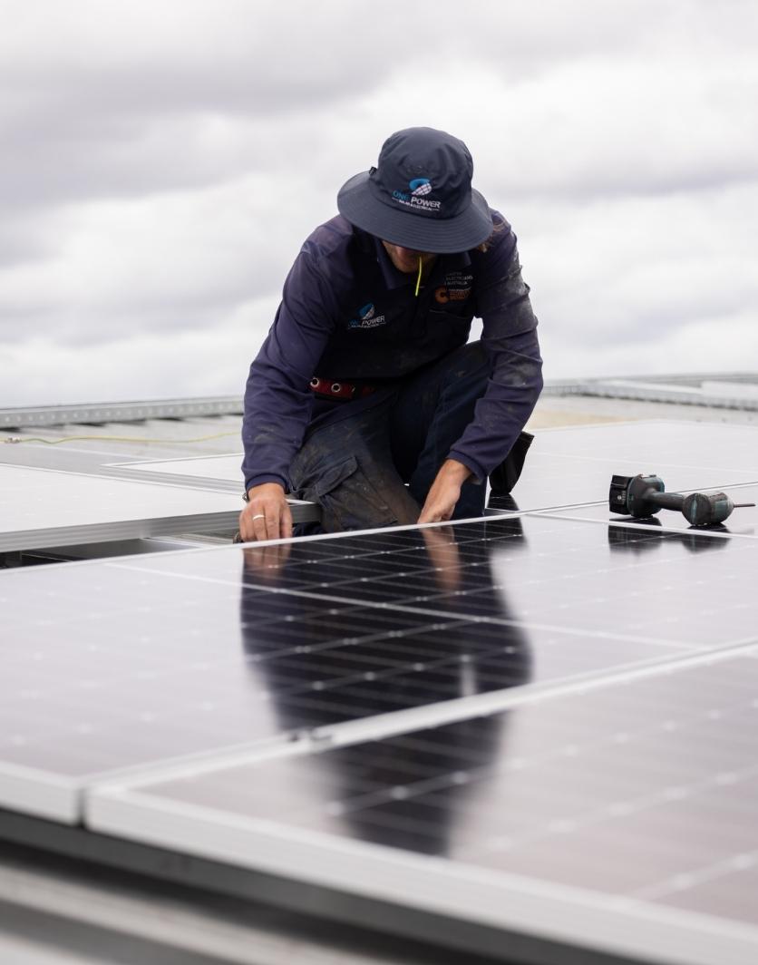 One Power Solar in-house team installing solar panels on a rooftop